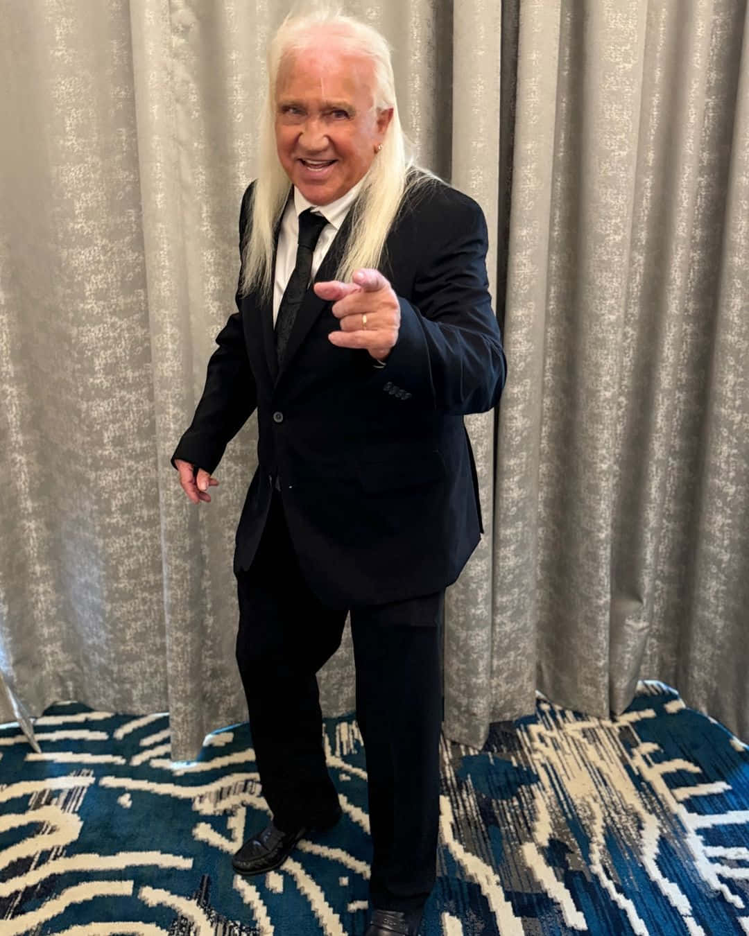 Ricky Morton Pointingat Camera Background
