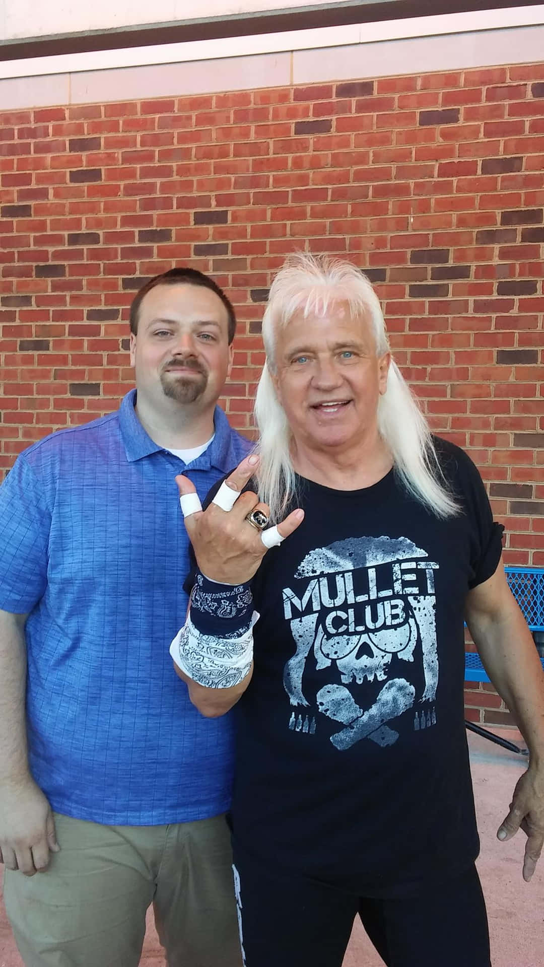 Ricky Morton Posing With A Fan Background