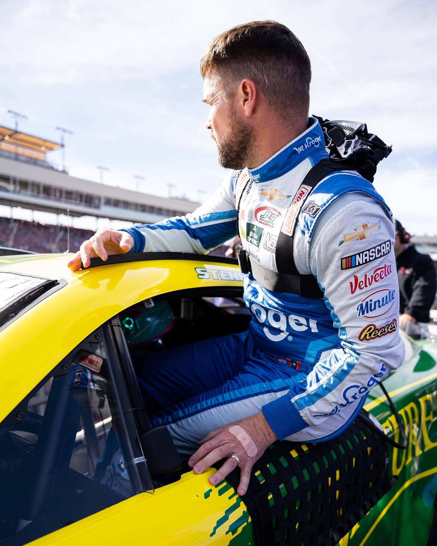 Ricky Stenhouse Jr. Exiting His Race Car At A Nascar Event.