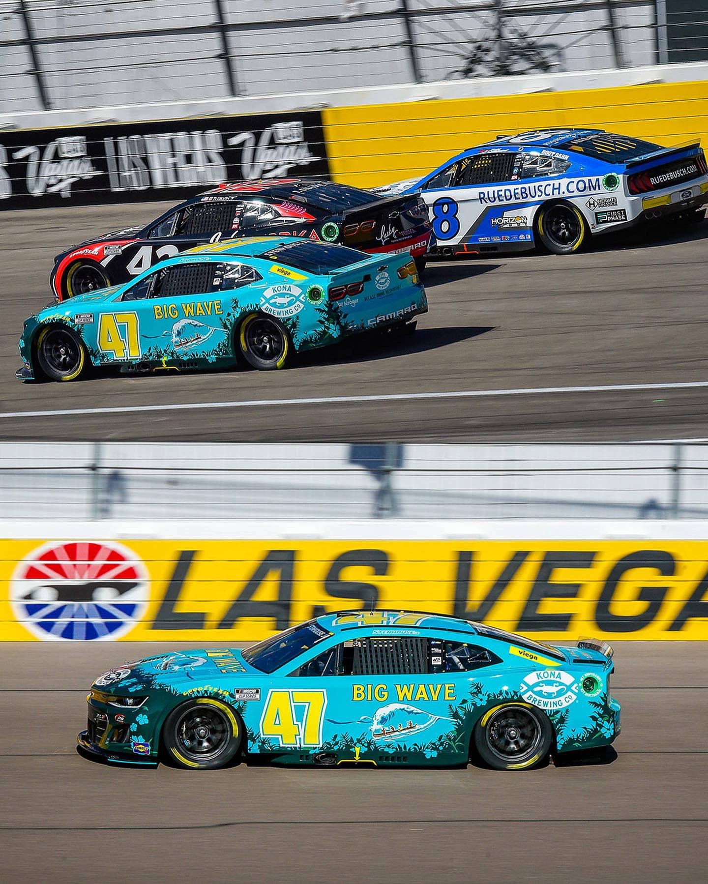 Ricky Stenhouse Jr., In His Dazzling Blue Racing Car, Vying For A Position On The Race Track.