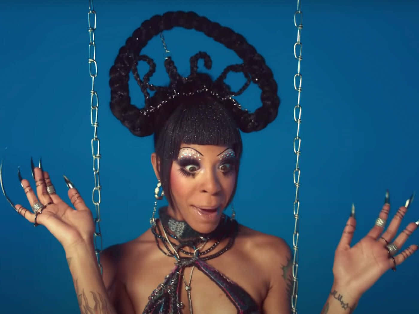 Rico Nasty Showing Her Unique Style In A Colorful Stage Outfit. Background