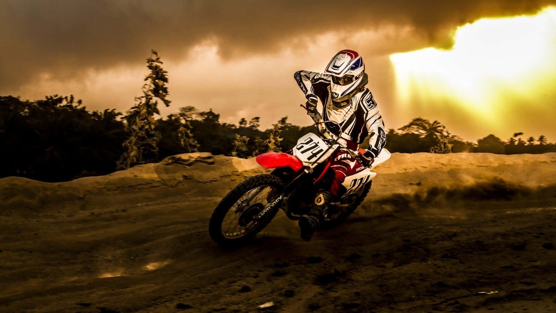 Ride Into Adventure With A Honda Dirt Bike Background