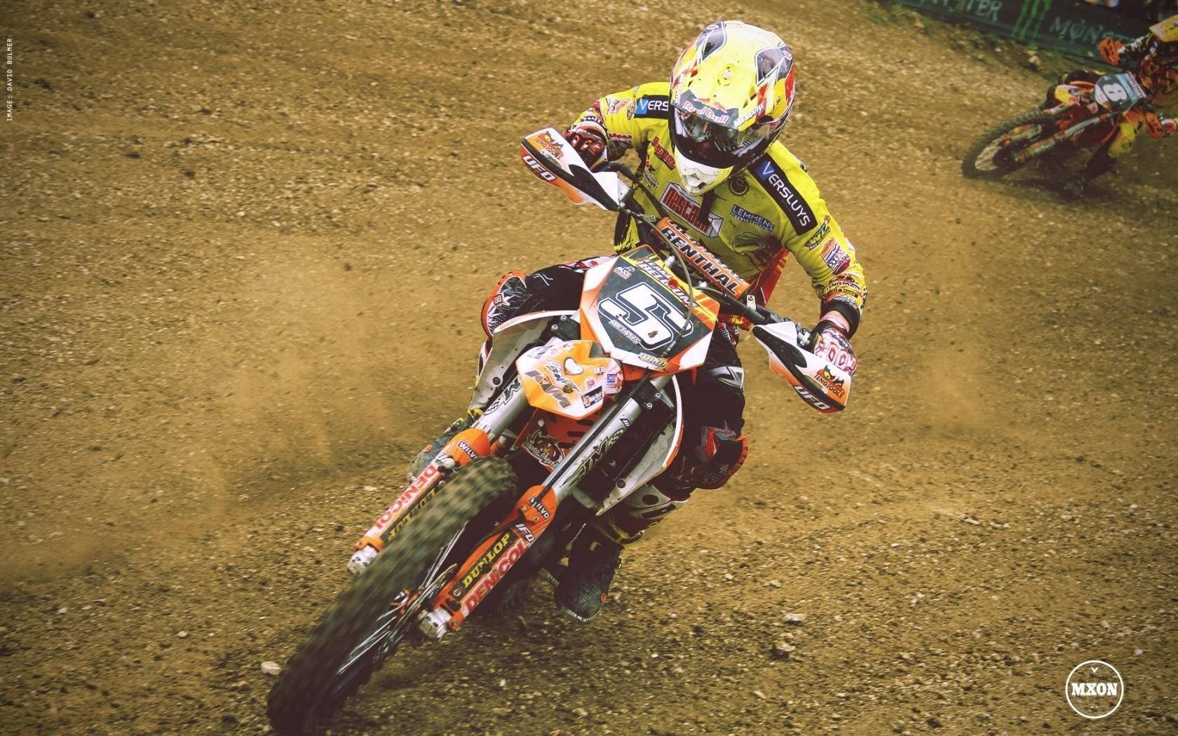 Rider In Mid-air Motocross Action Background