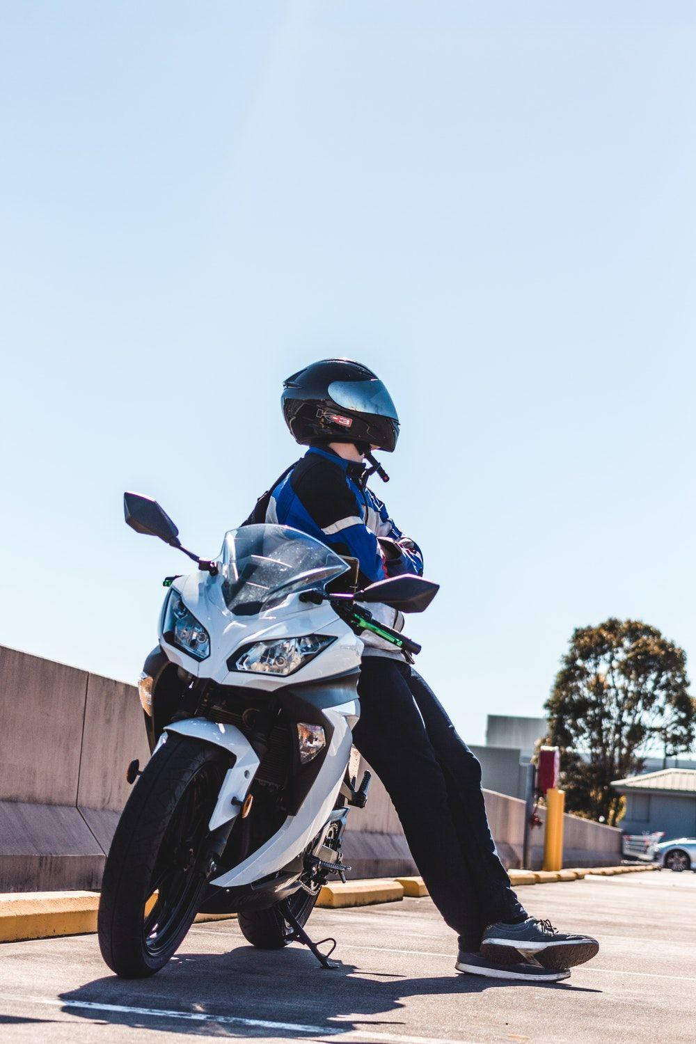 Rider Sitting On White Bikes Background