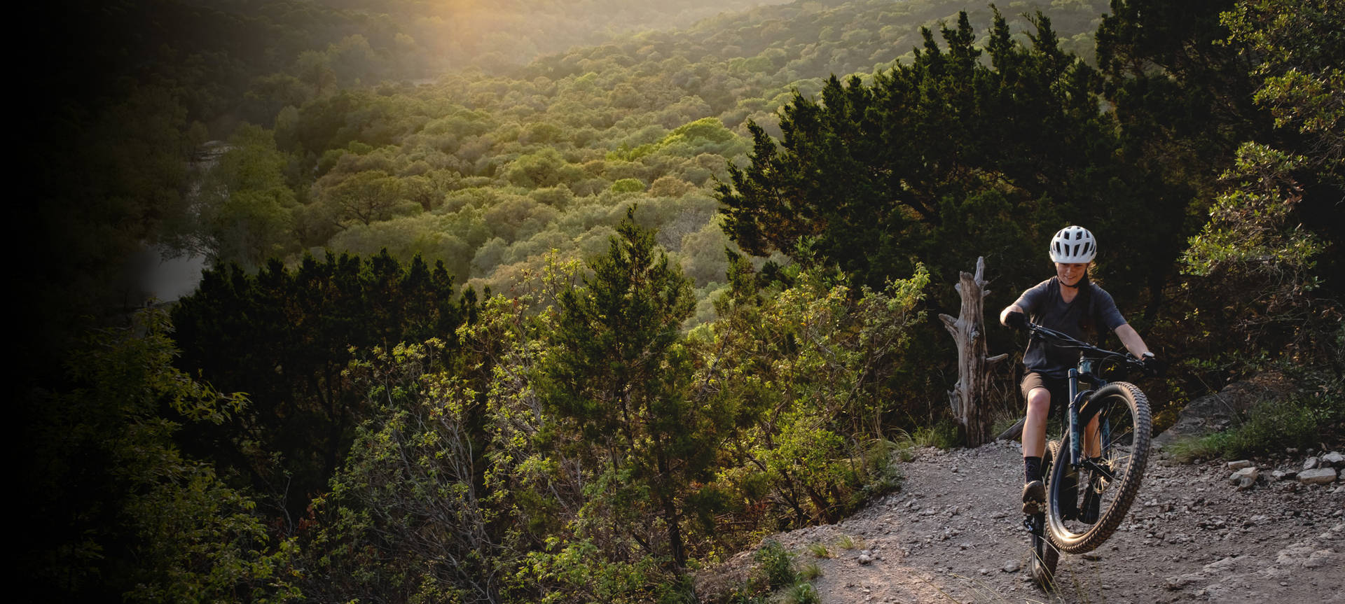 Riding Specialized Bike On Mountain Trail Background