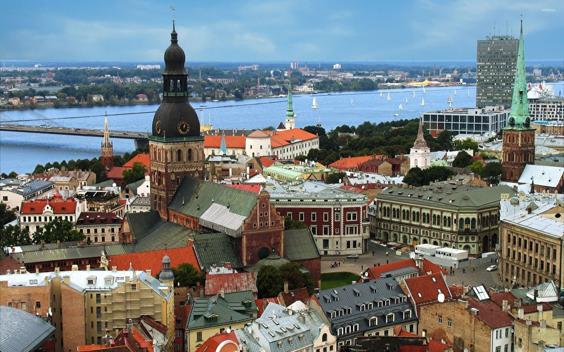 Riga Cathedral And St. Peter's Church In One Photo Background