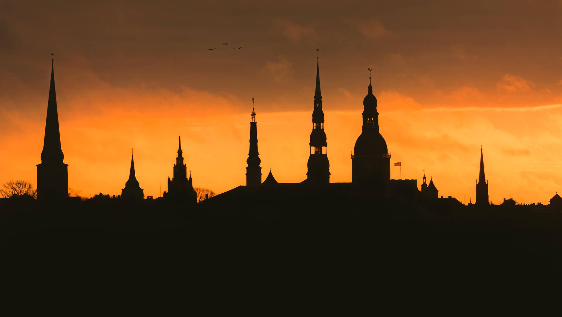 Riga's Steeples On A Sunset Background