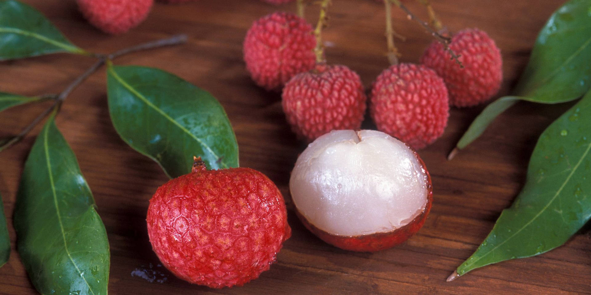 Ripe Lychee Fruit And Leaves Background