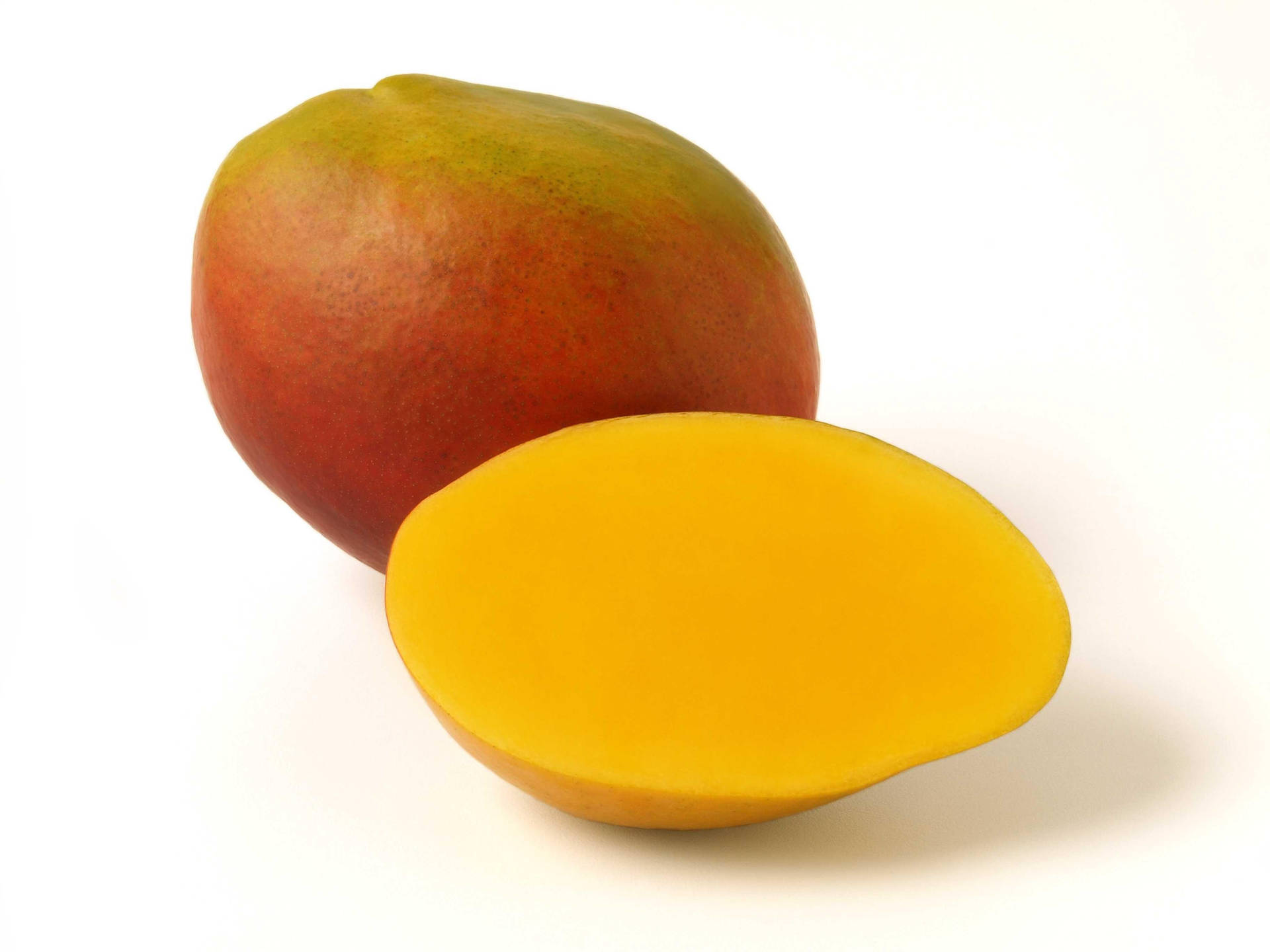 Ripe Mango Fruit On A Wooden Surface Background