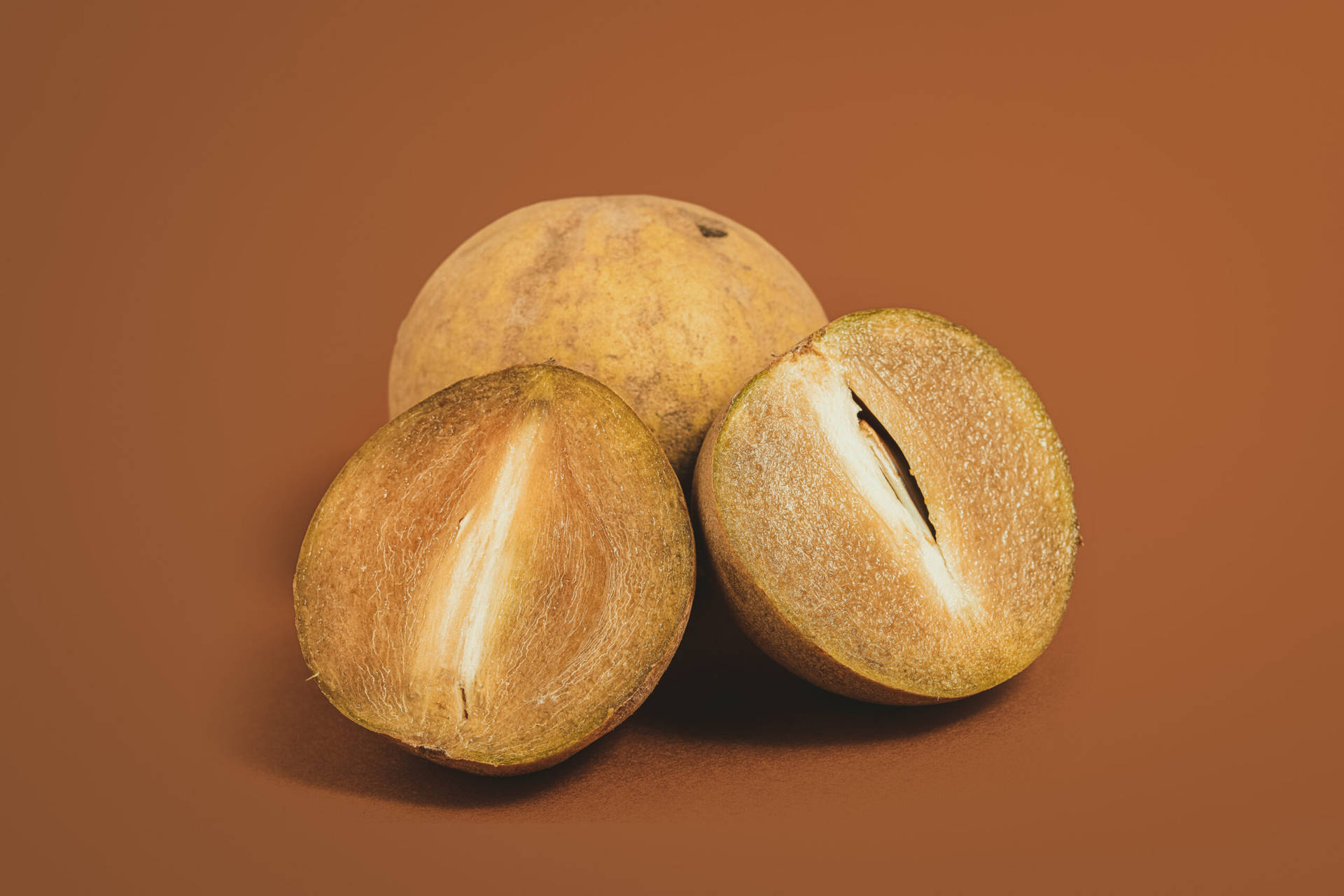 Ripe Sapodilla Fruits On A Rustic Setting Background