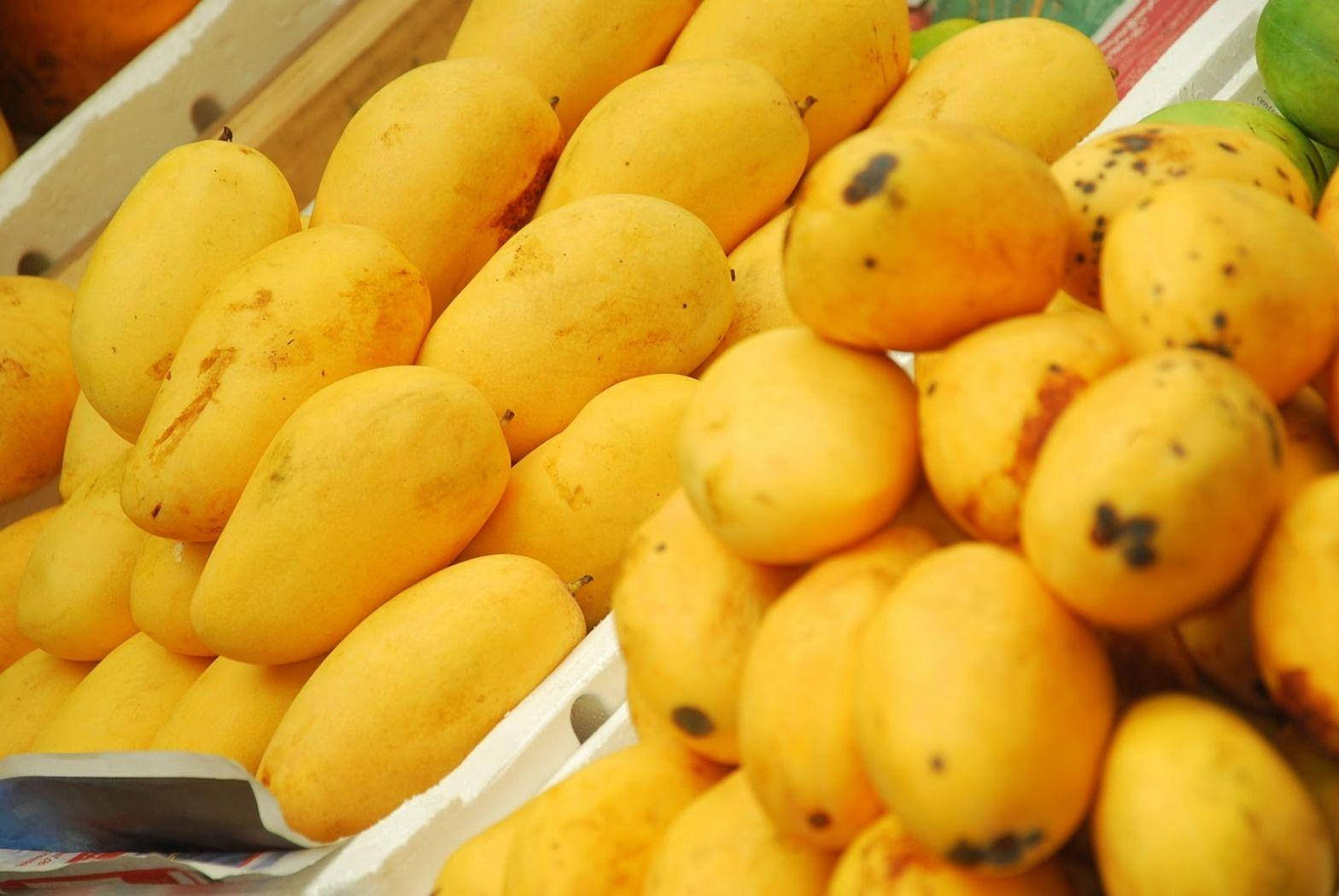 Ripe Yellow Mango Fruits At The Supermarket Background