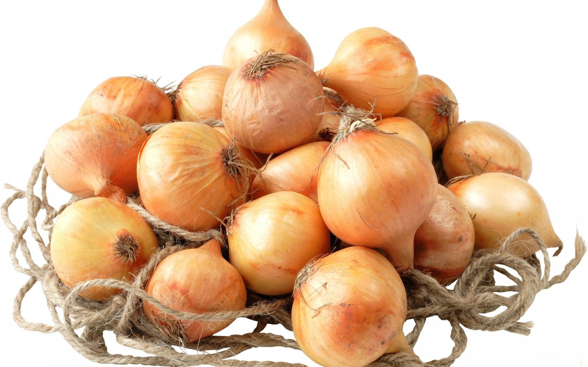 Ripe Yellow Onions On Jute String Background