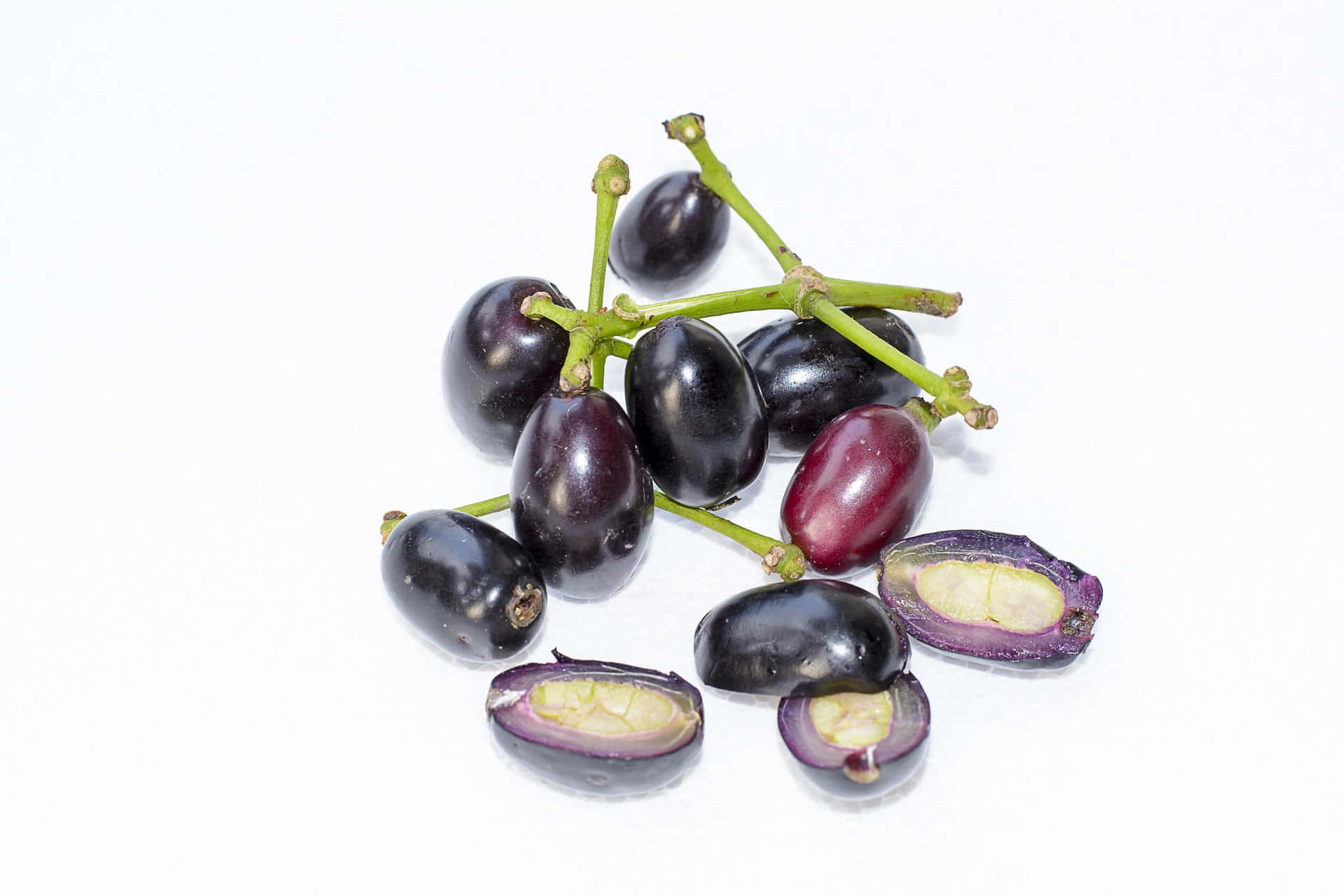 Ripened Java Plums Split Open Displaying Their Vivid Red Interior Background