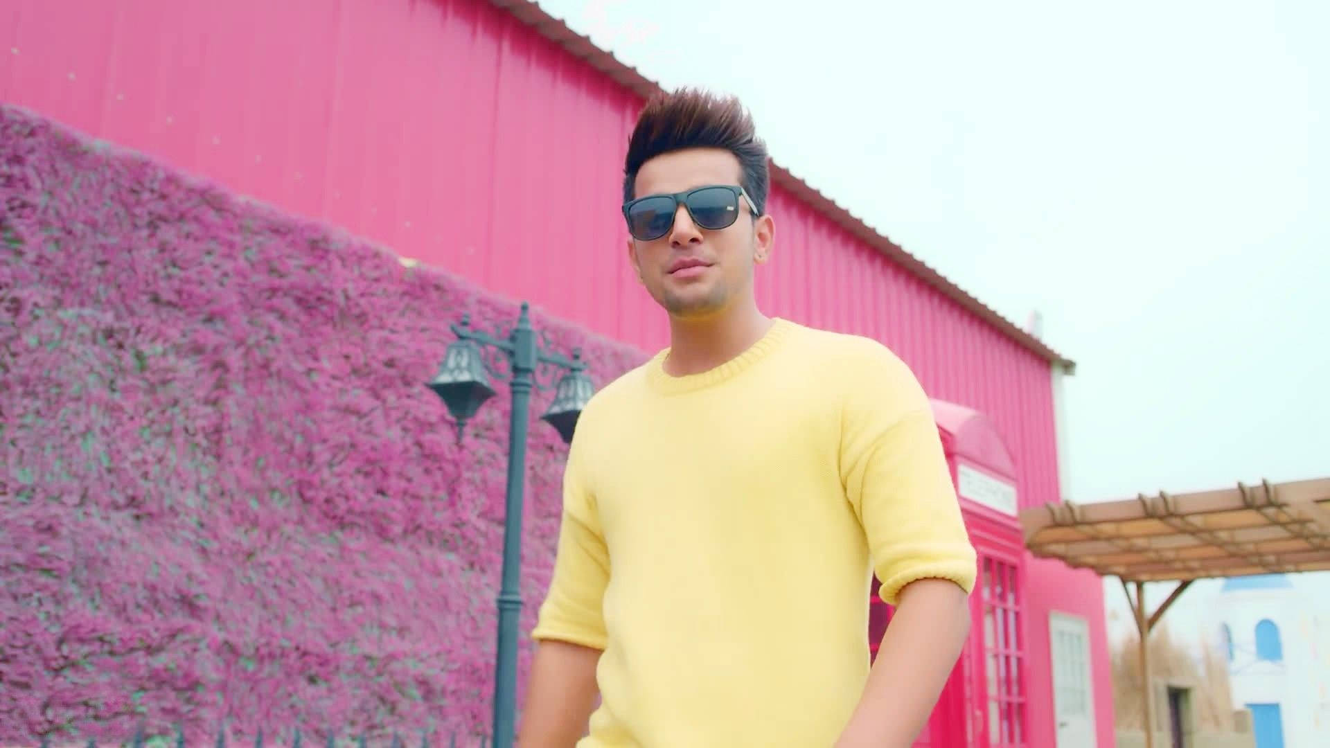 Rising Star Jass Manak In Vibrant Yellow Sweater Background