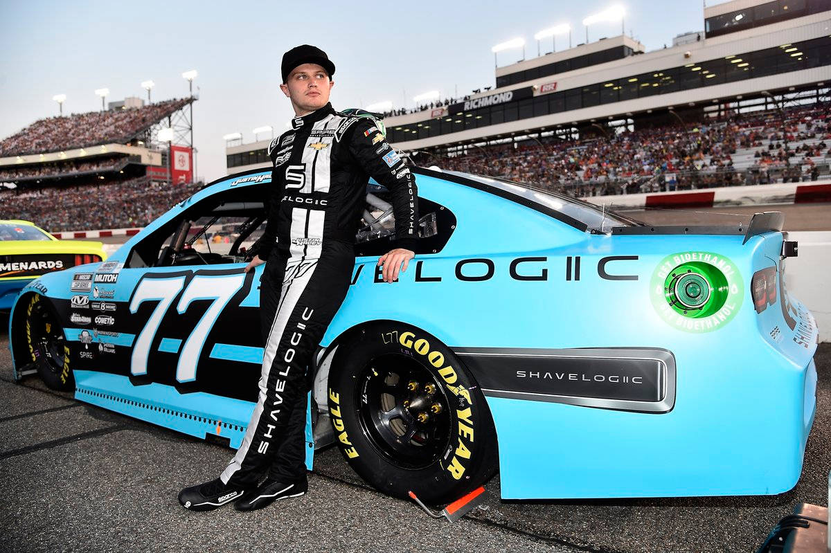 Rising Star Justin Haley In His Aqua Blue Race Car Background