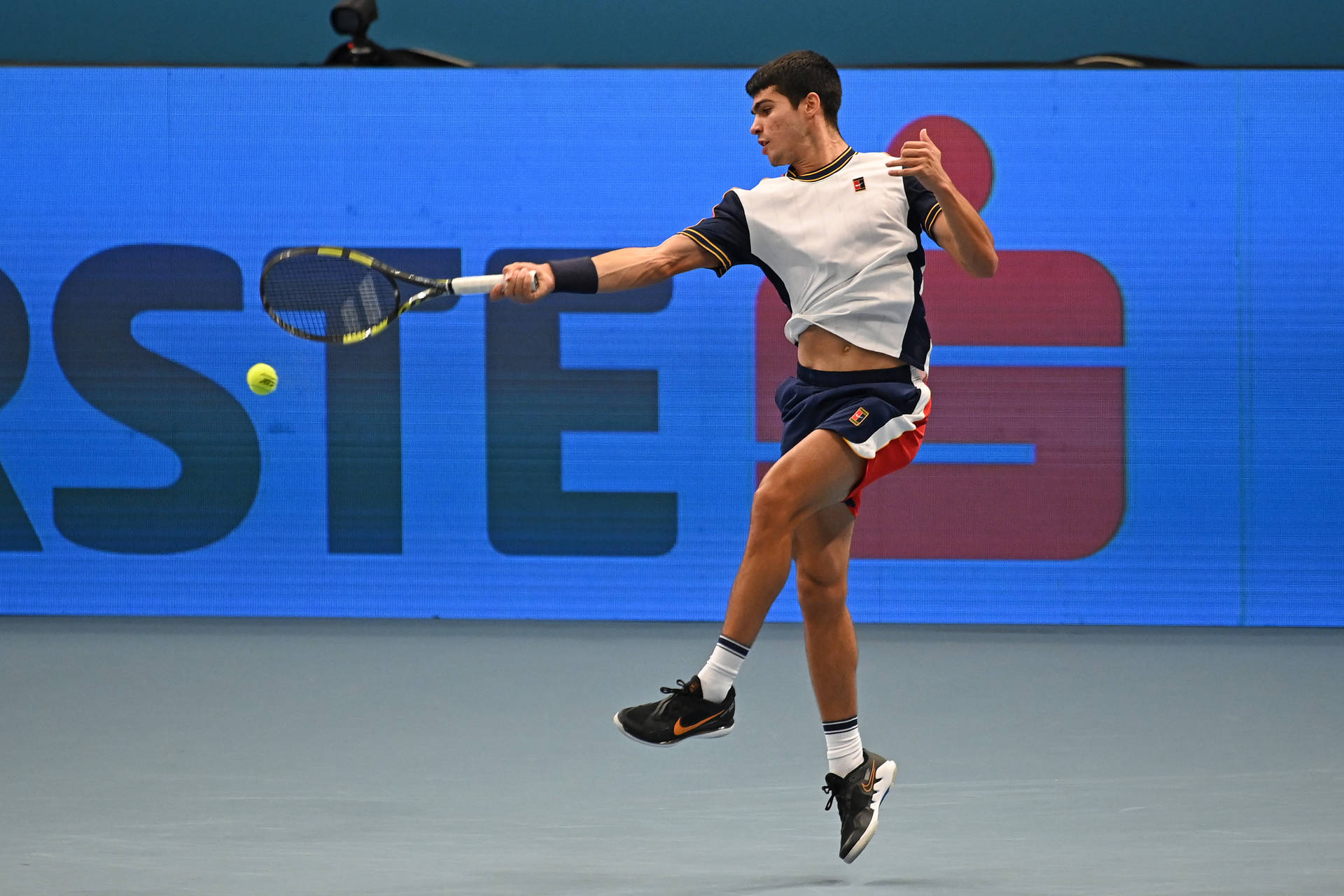 Rising Tennis Star Carlos Alcaraz In Action Background