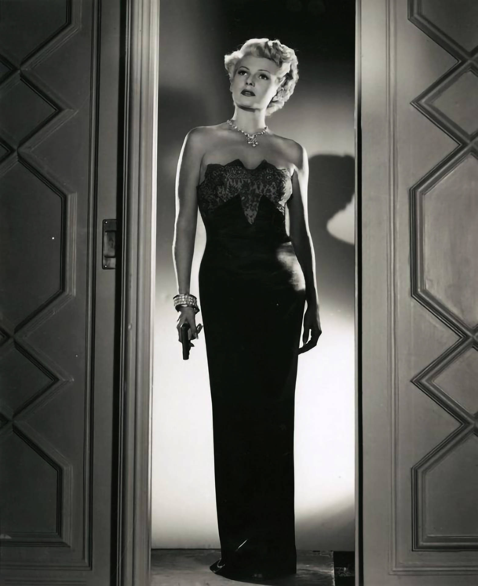 Rita Hayworth Holding A Gun Background