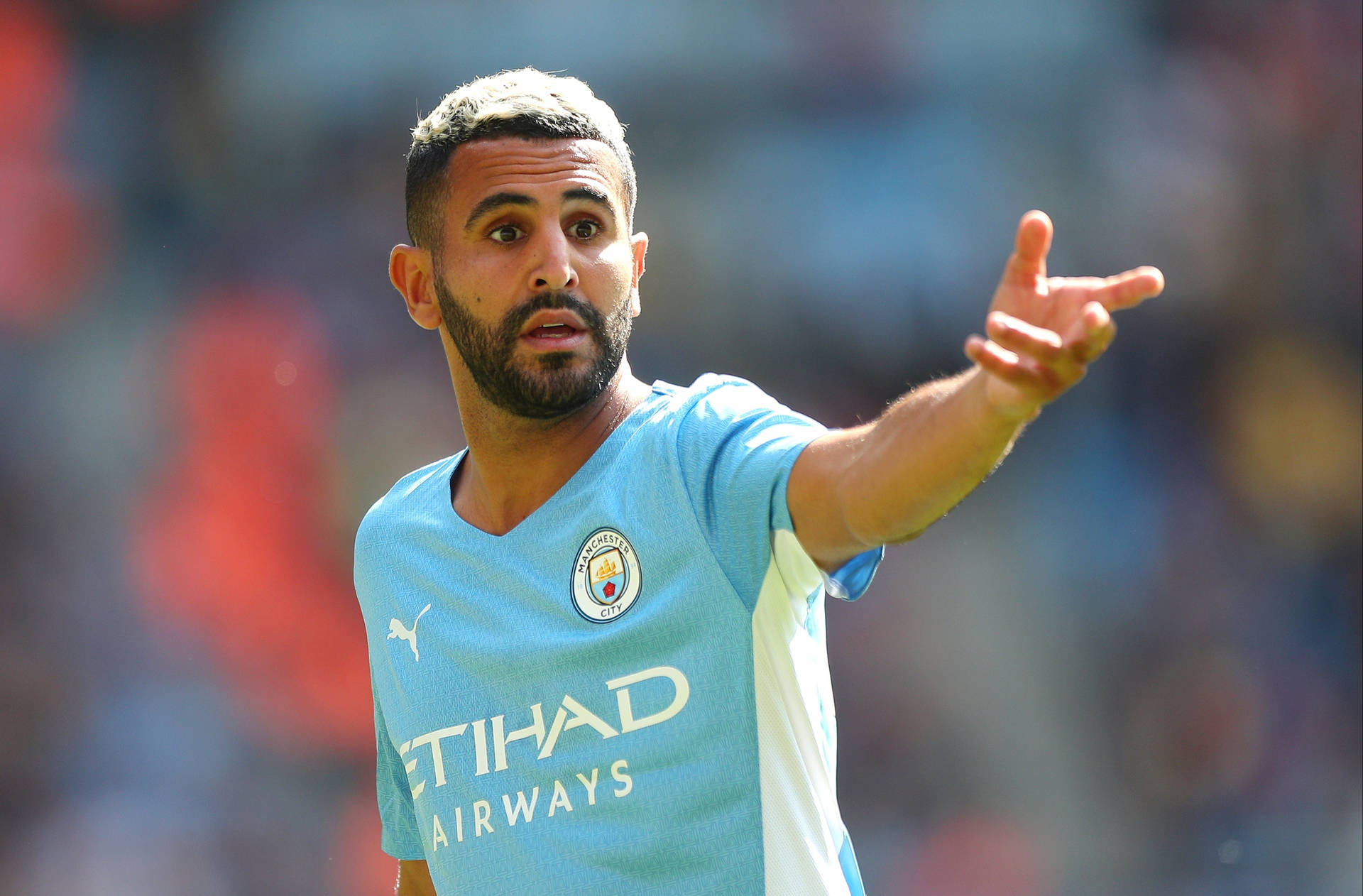 Riyad Mahrez Pointing Left Background