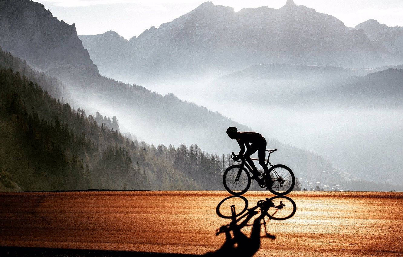 Road Bike Ride In Foggy Mountain Background