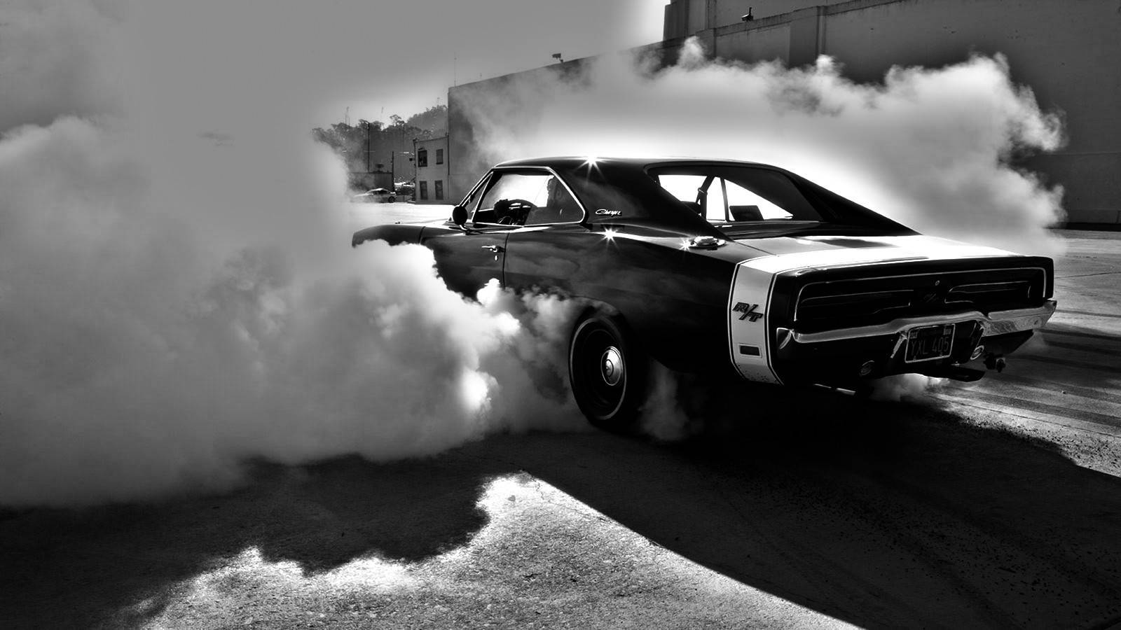 Roaring Muscle Car Enveloped In Smoke Background