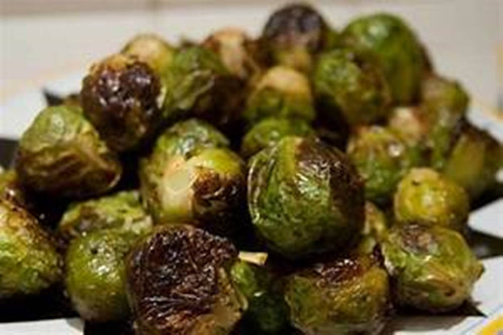 Roasted Brussels Sprouts On A White Plate Background