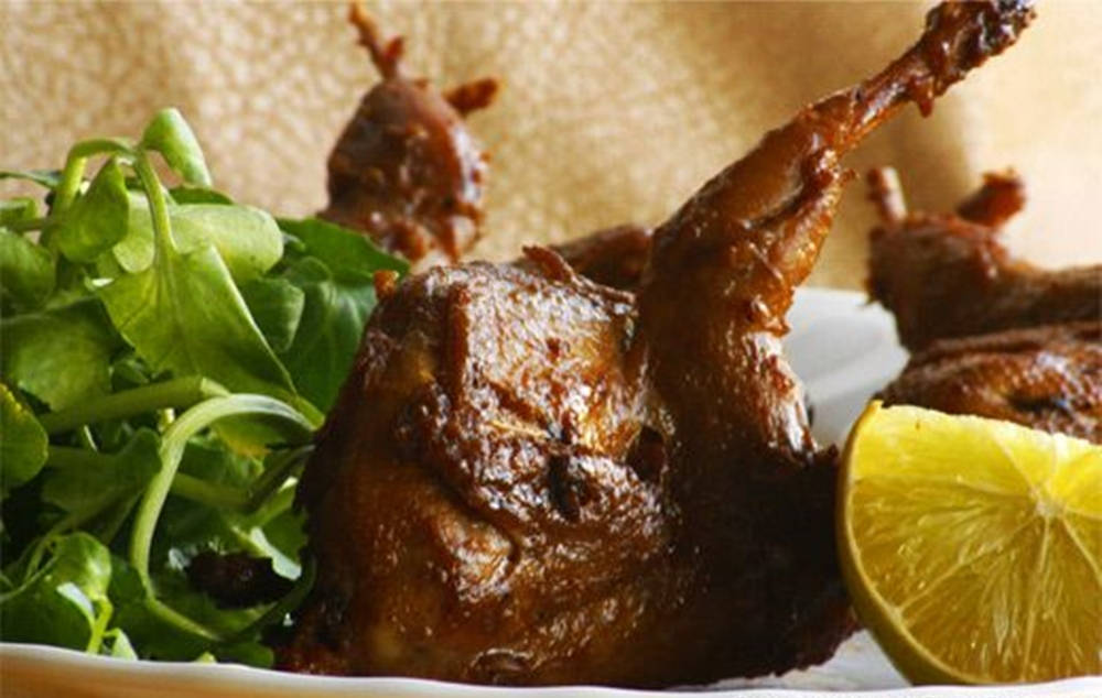 Roasted Quail With Leaves And Lemon Background