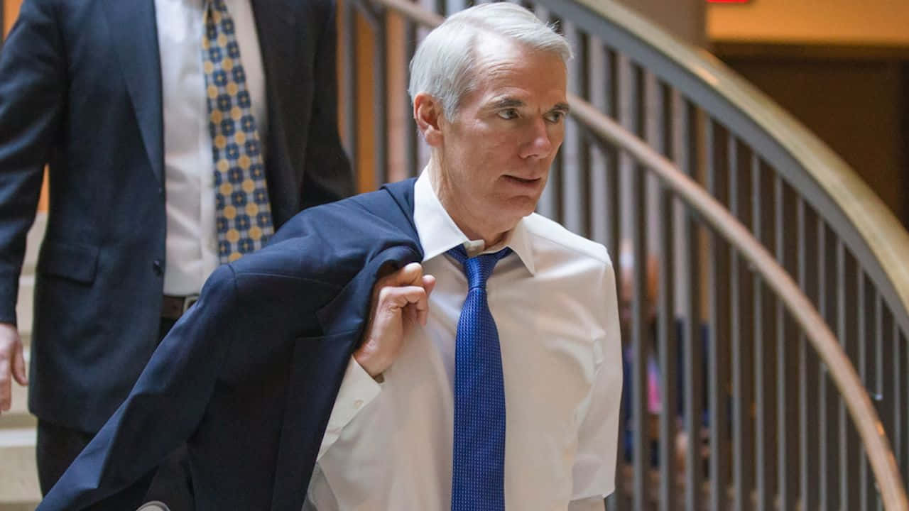 Rob Portman Holding Blazer Background