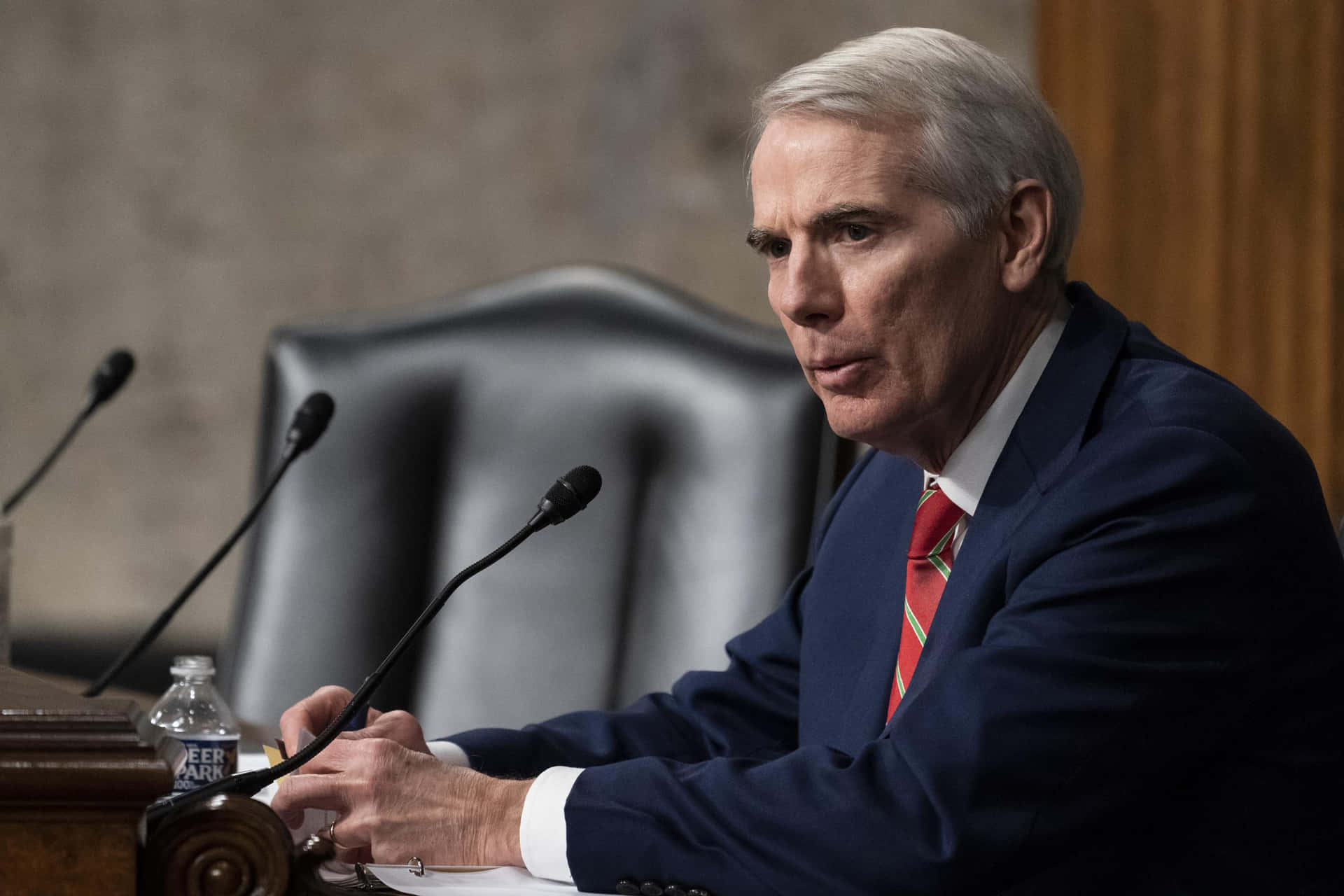 Rob Portman Leaning On Conference Table