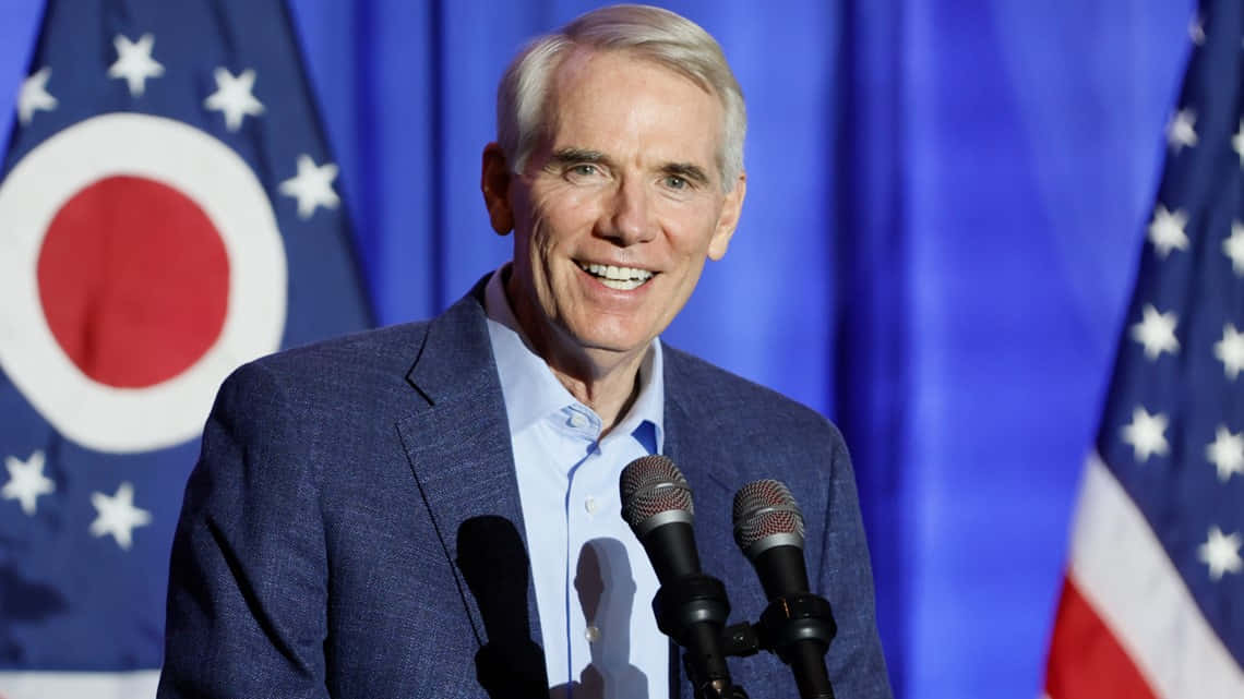 Rob Portman Smiling From Podium Background