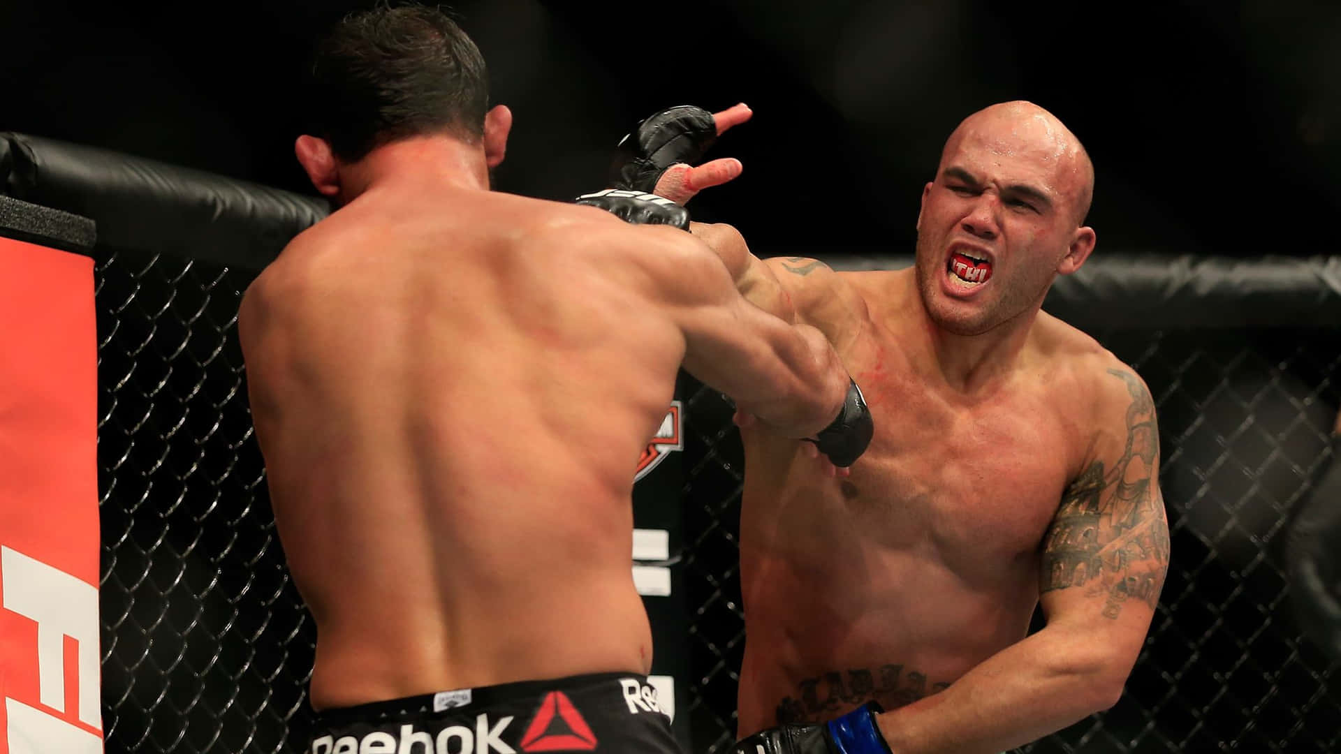 Robbie Lawler Lands A Hit On Johny Hendricks Background