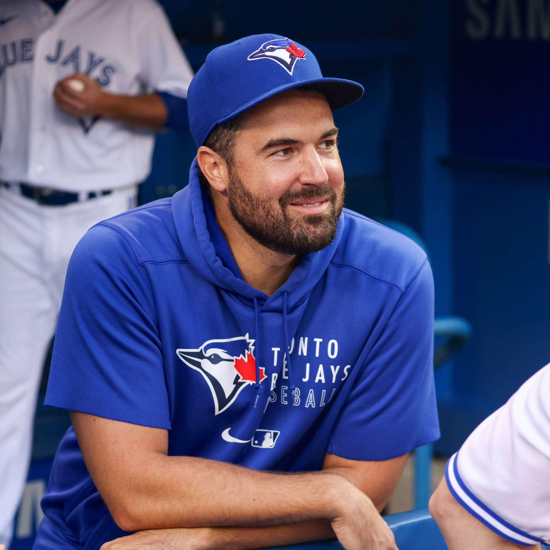 Robbie Ray Smiling At Baseball Benches Background