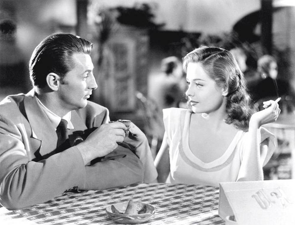 Robert Mitchum And Jane Greer At Table Background