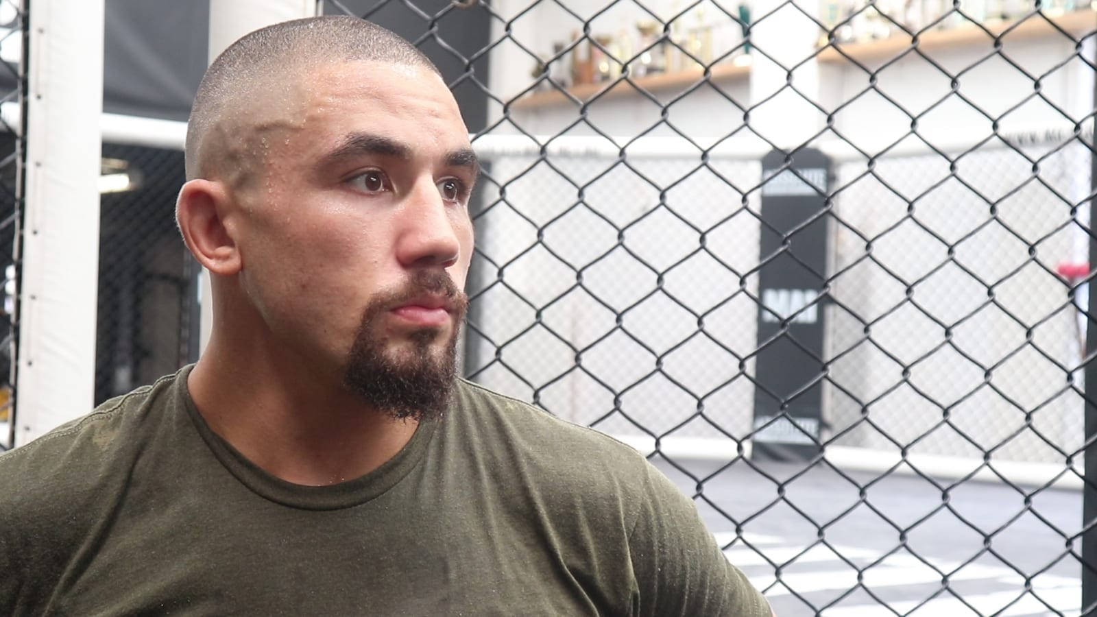 Robert Whittaker Against Octagon Cage Background