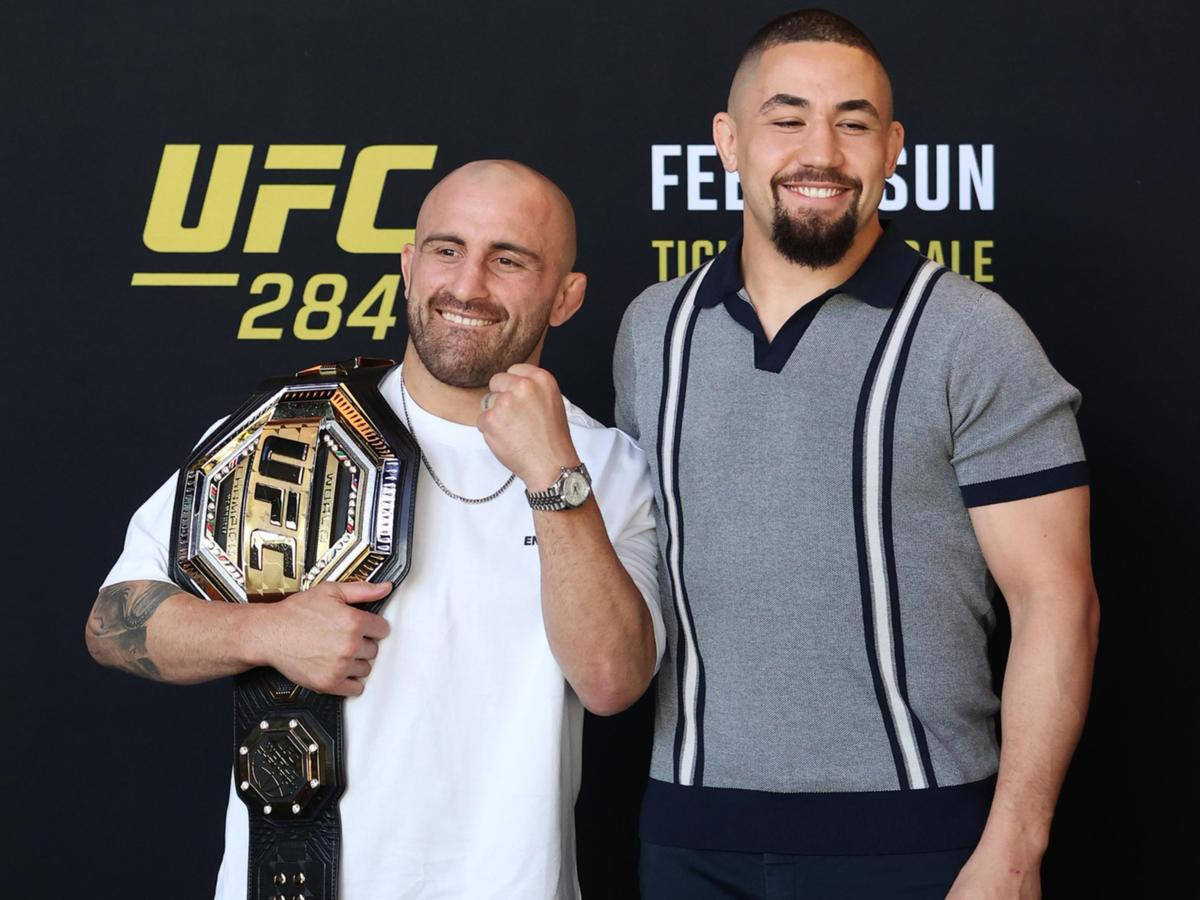 Robert Whittaker Alongside Alexander Volkanovski Against Their Shared Training Backdrop Background