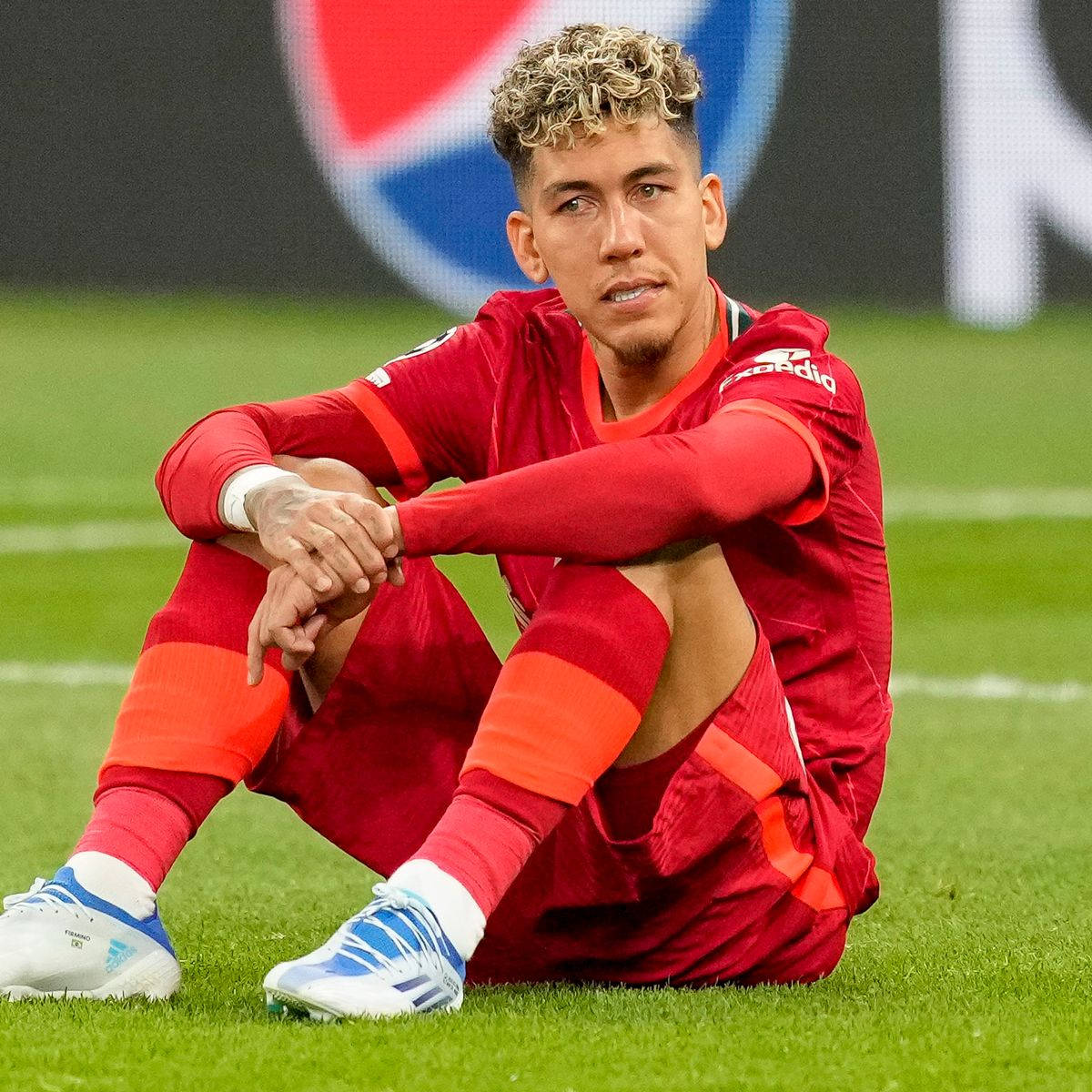 Roberto Firmino Sitting Pepsi Logo Background