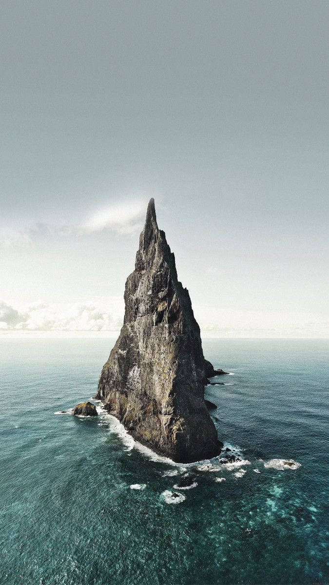 Rock Formation Middle Of The Ocean Iphone Background