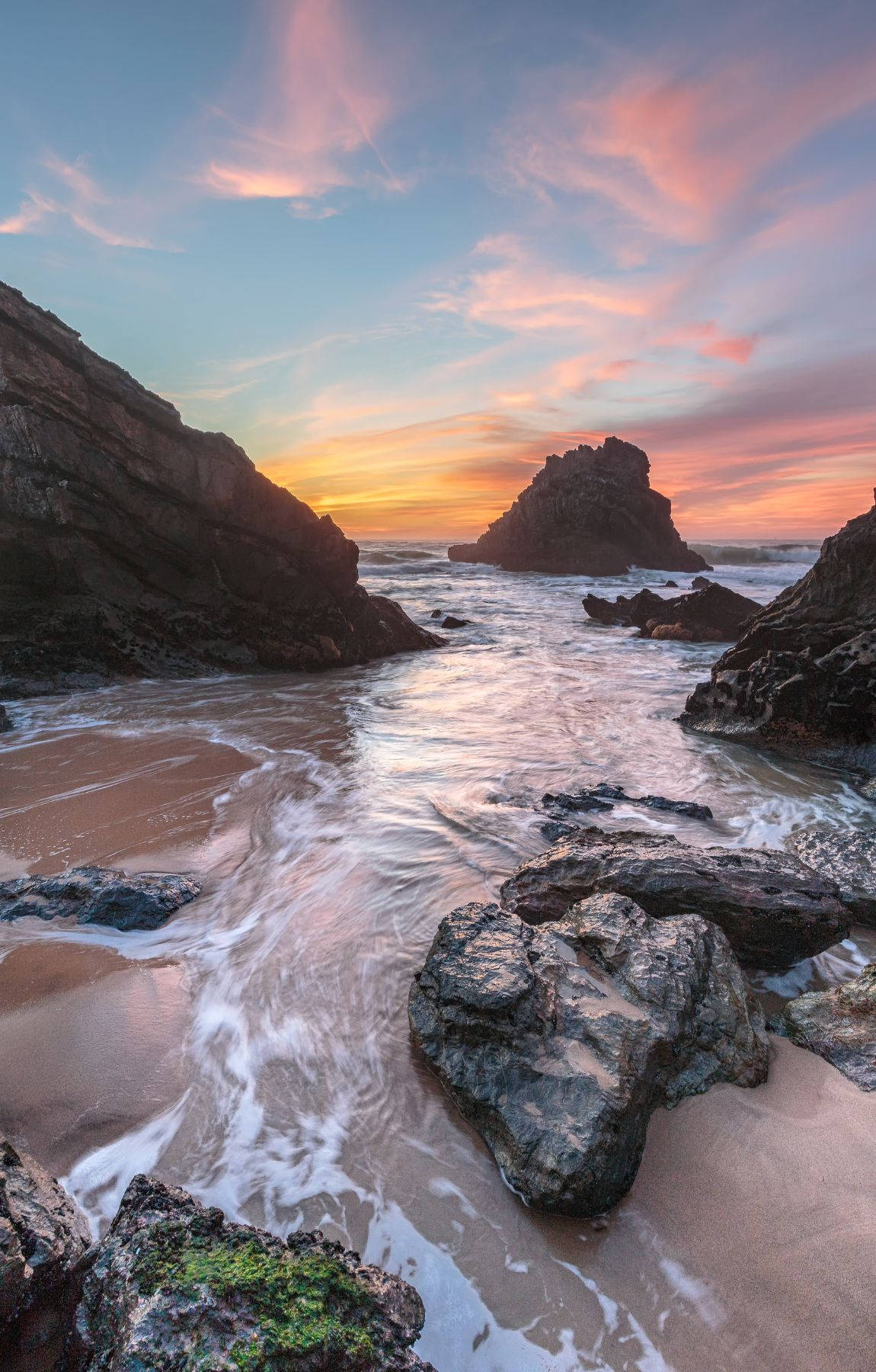 Rock Formation On Beach Sunrise Background