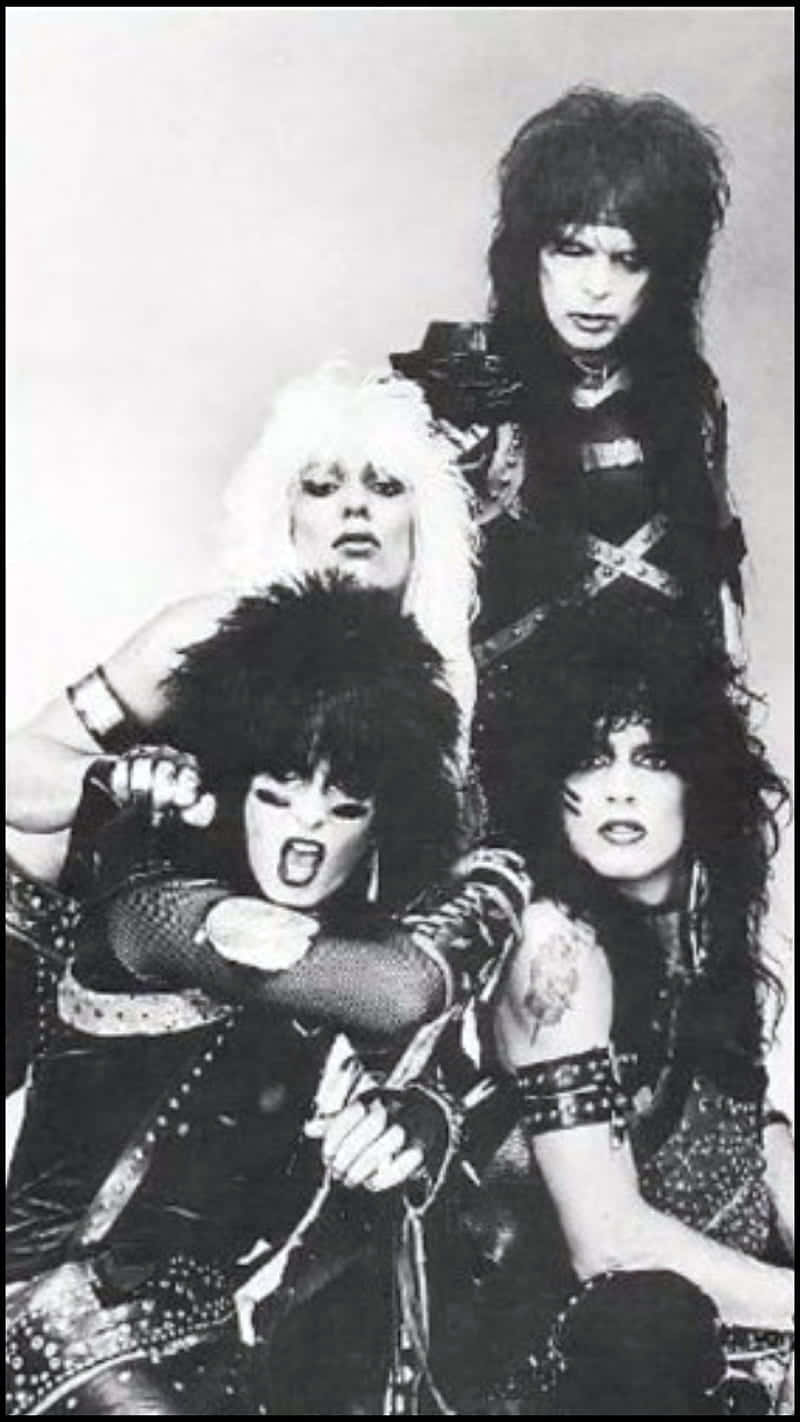 Rocking Out On Stage At Livewire – Motley Crue Background