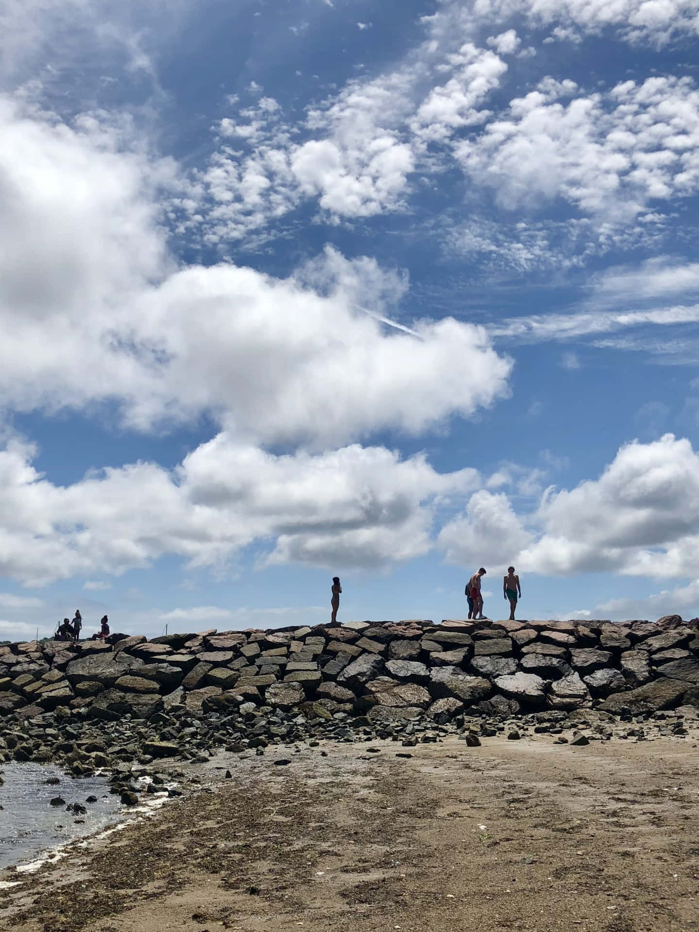 Rocky Beach Promenade Under Cloudy Sky