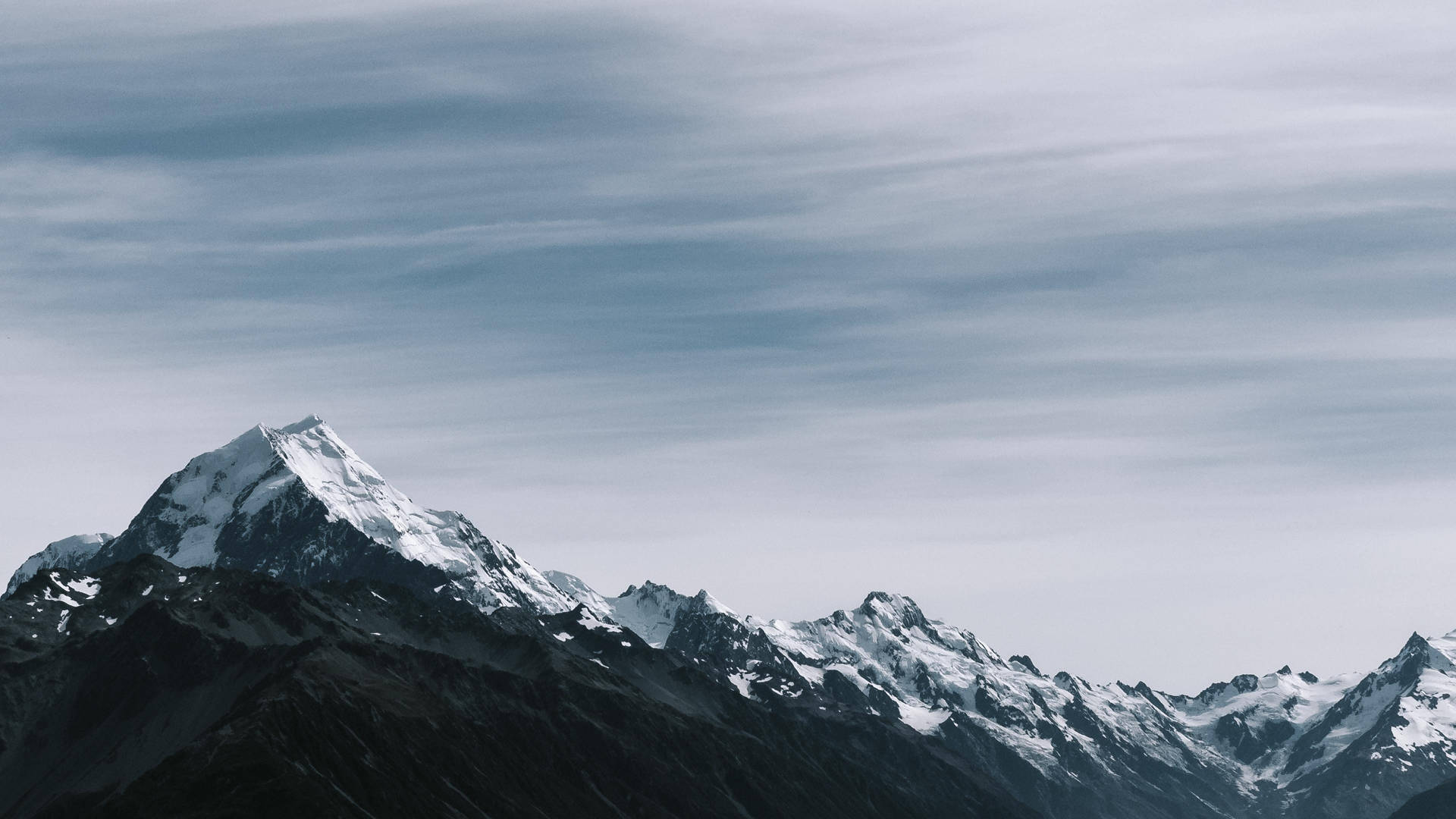 Rocky Mountain Beneath Gray Sky Background