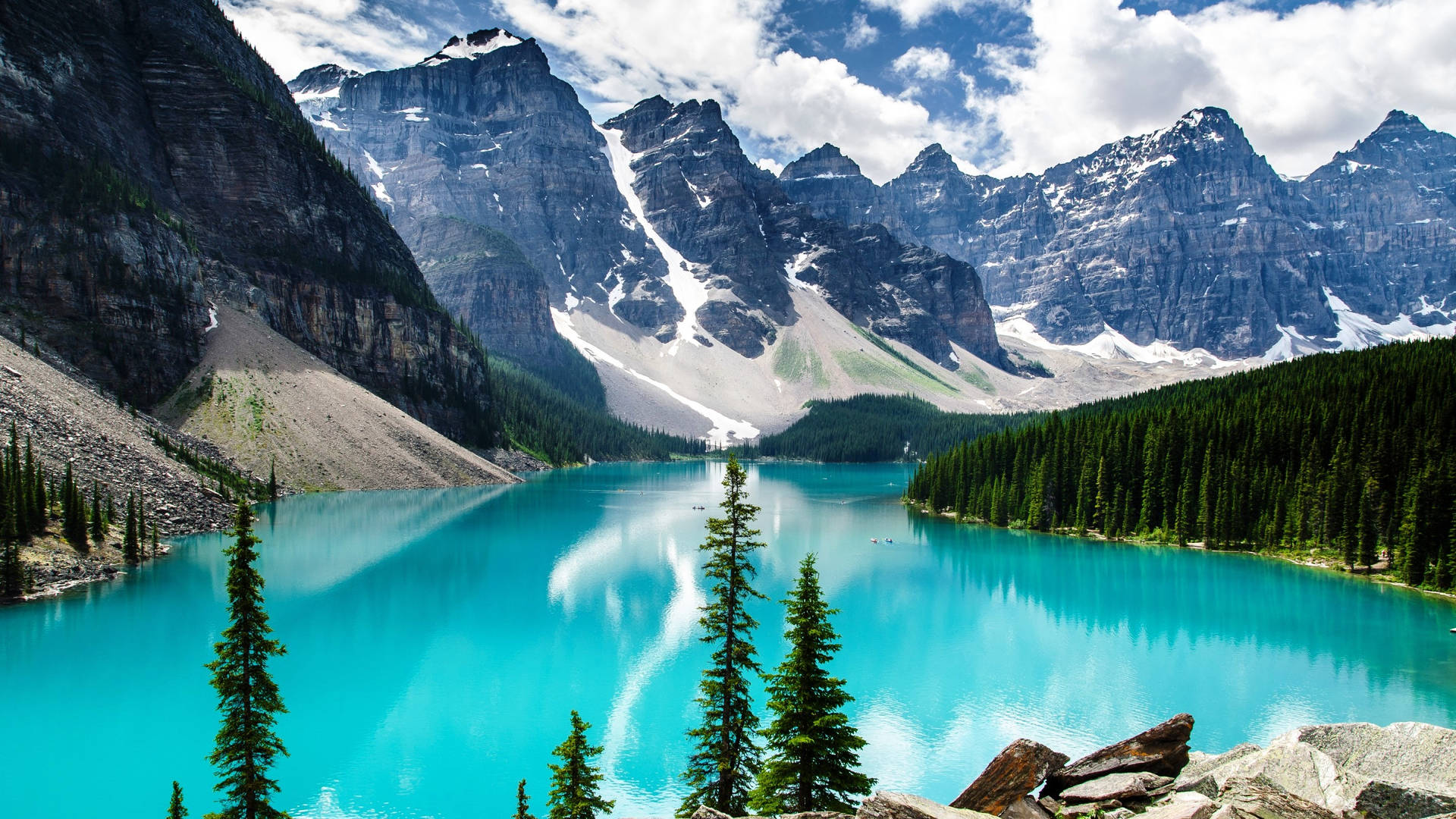 Rocky Mountain With Forest Surrounding Body Of Water Background