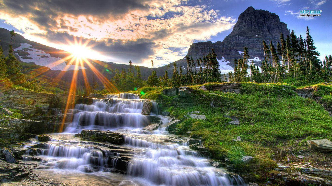 Rocky Mountain With Grassy Waterfall Background