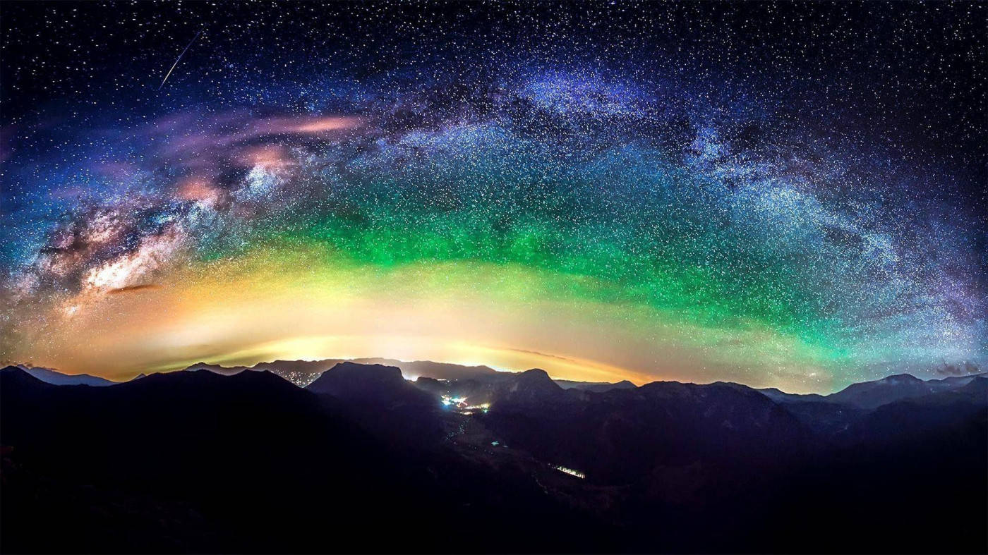 Rocky Mountains With Colorful Cosmos Overhead Background