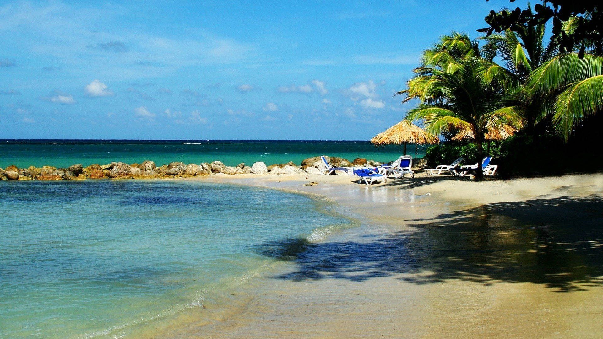 Rocky White-sand Beach In Montego Bay Background