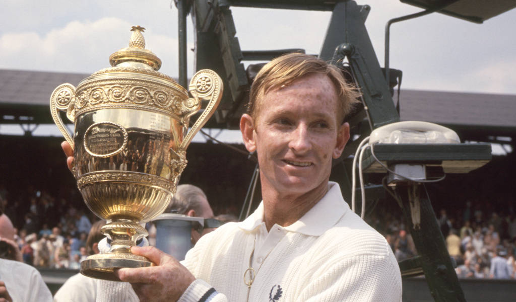 Rod Laver Triumphantly Lifting The Wimbledon Trophy Background