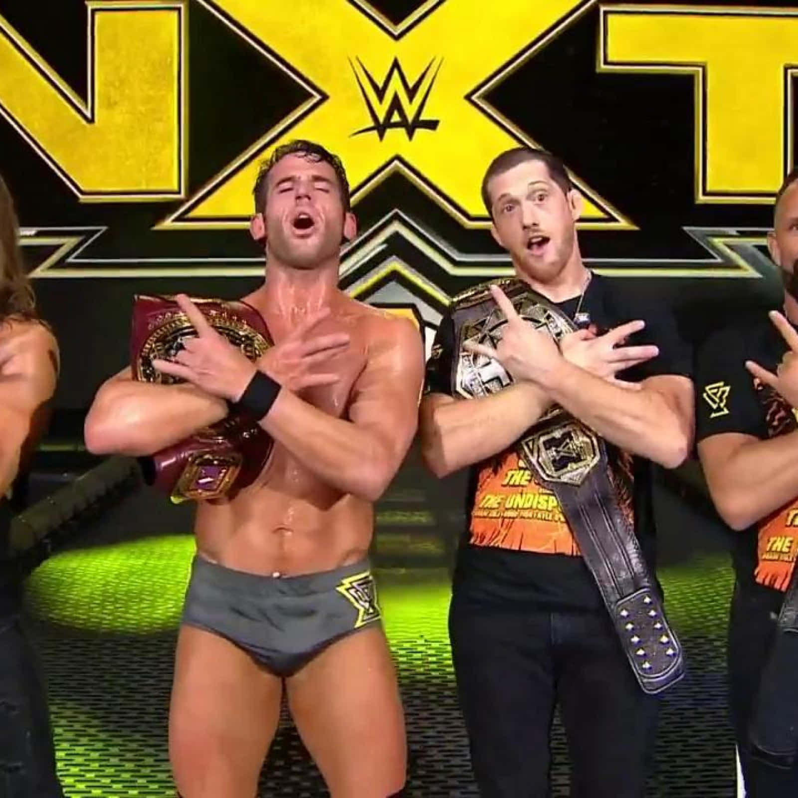 Roderick Strong Making The Iconic Rock Sign During A Wrestling Event Background