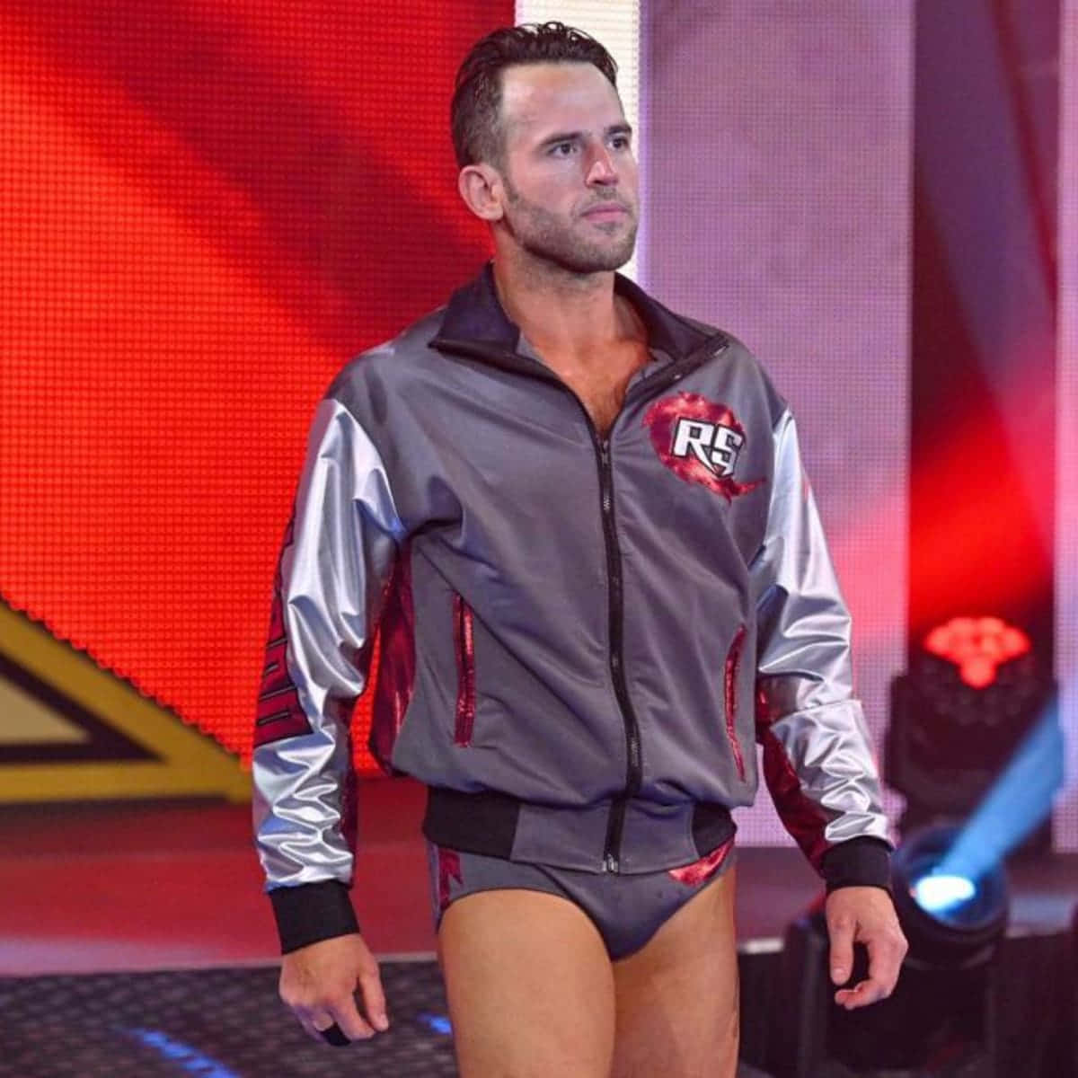 Roderick Strong, The Professional Wrestler, Posing Confidently In His Sports Jacket And Singlet Background