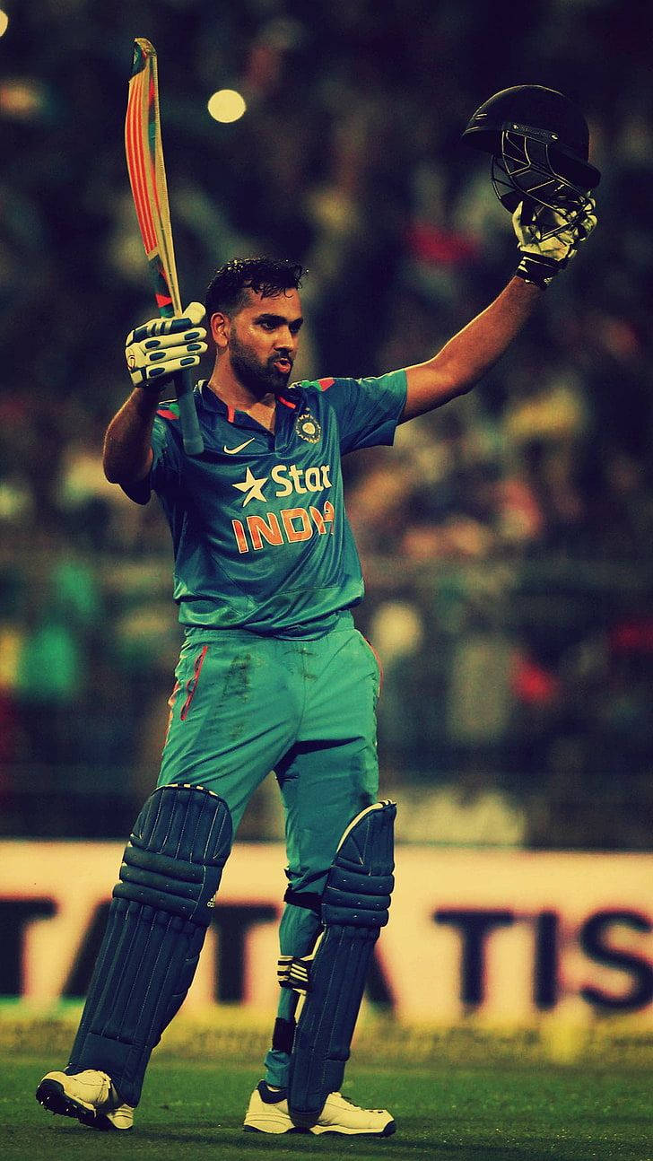 Rohit Sharma In Green Cricket Uniform Background