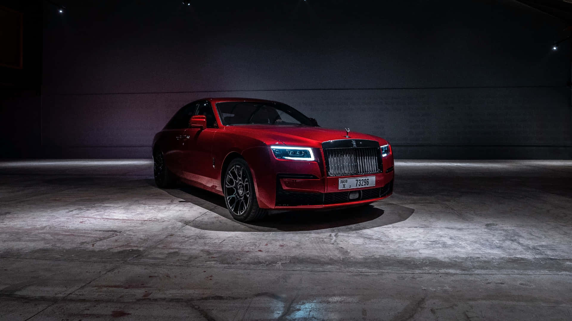 Rolls Royce Phantom - A Red Car In A Dark Room Background