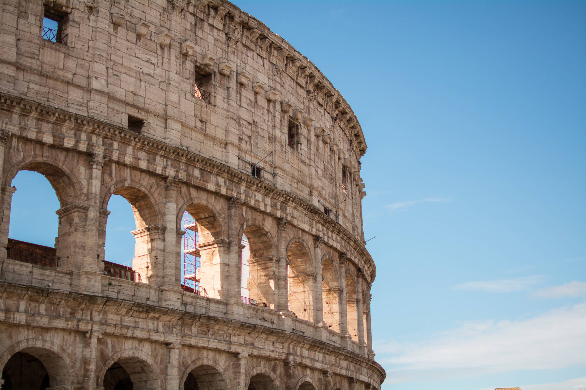 Roman Colosseum In Front Of The Blue Sky Background